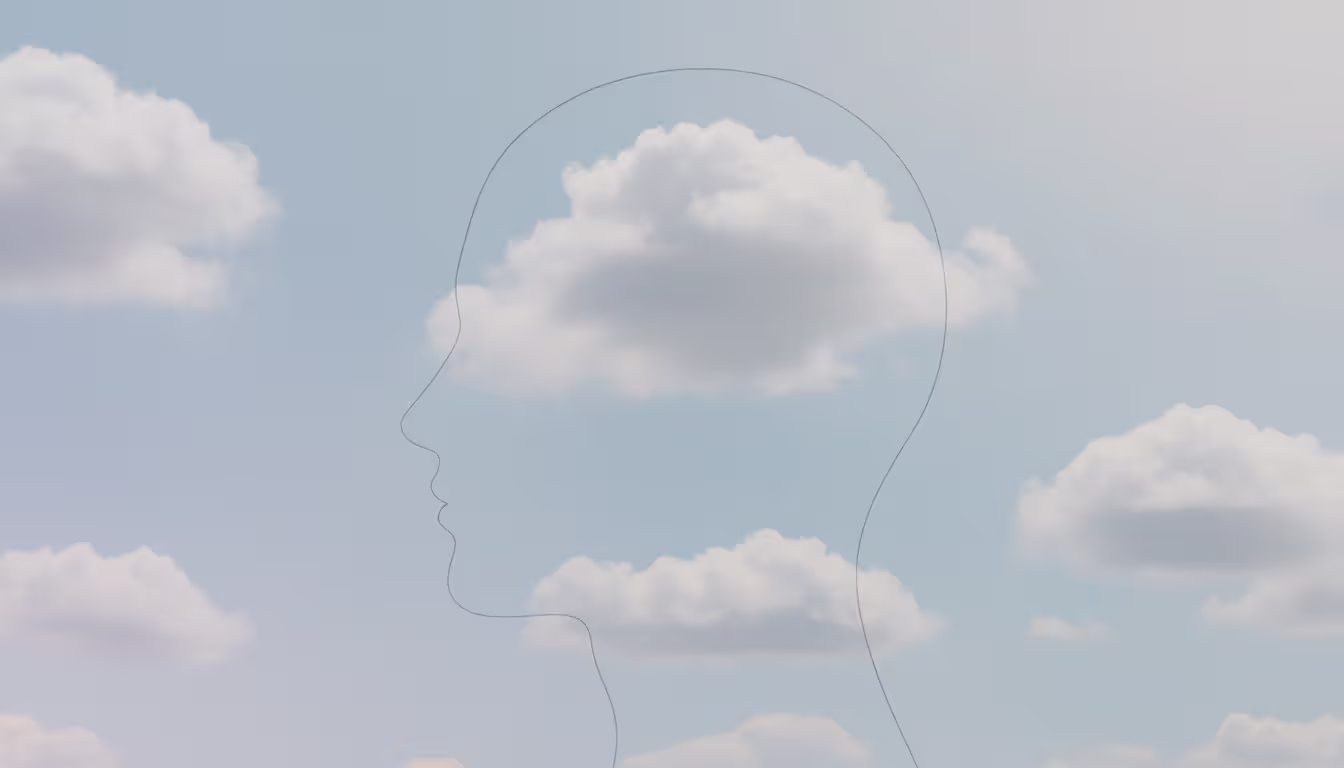 Profile silhouette of a human head filled with soft clouds floating across a blue sky, representing thoughts passing through awareness